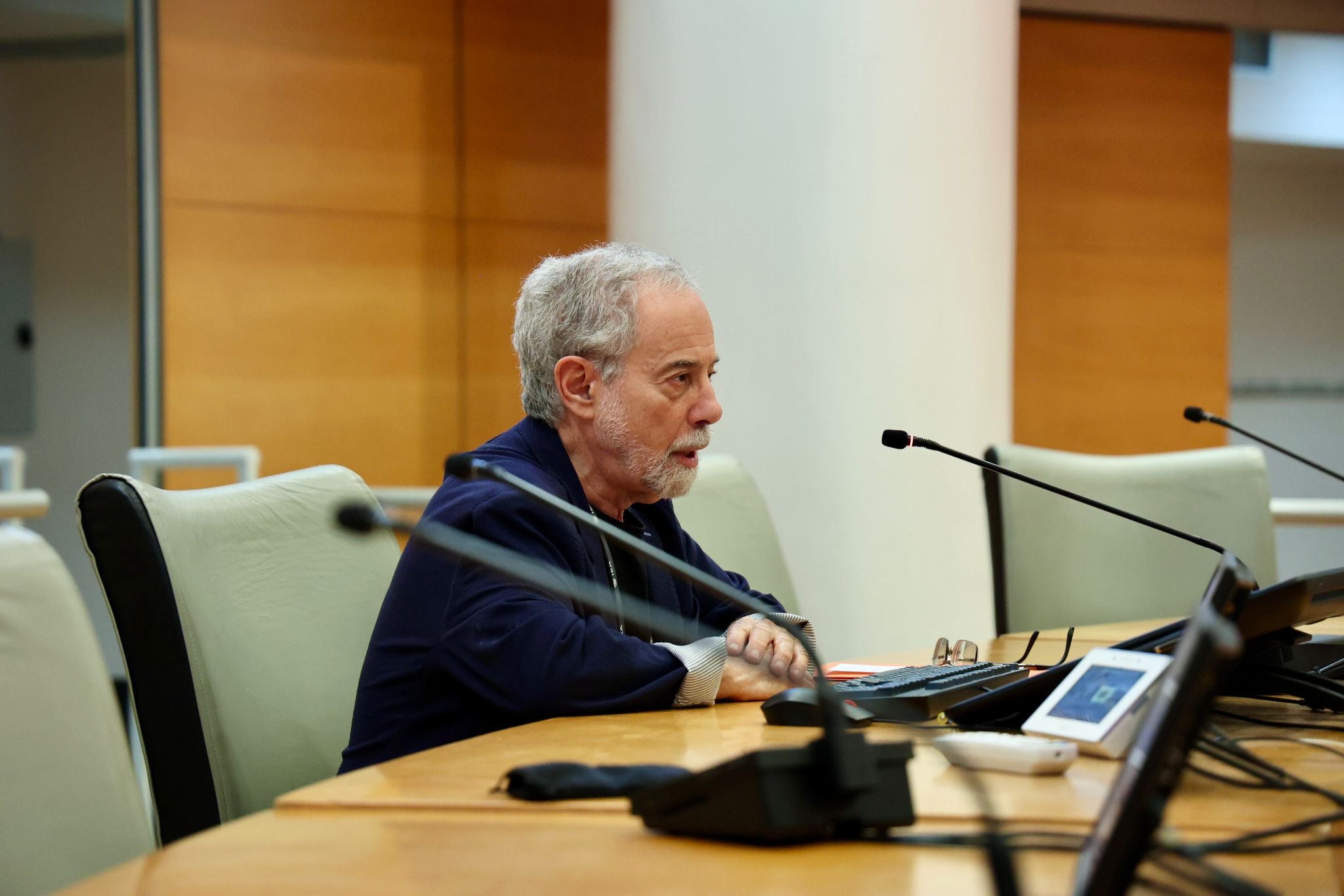 Image of keynote speaker Henry Braun speaking into a gooseneck microphone