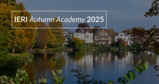 Landscape of ponds, trees, and houses, with IERI Autumn Academy 2025 text